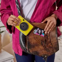 Canon Zoemini C Instant Camera Colour Photo Printer, Bumblebee Yellow Girl pulling out the Printer from a bag