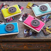 Canon Zoemini C Instant Camera Colour Photo Printer, Seaside Blue 4 Printers displayed on desk with photos
