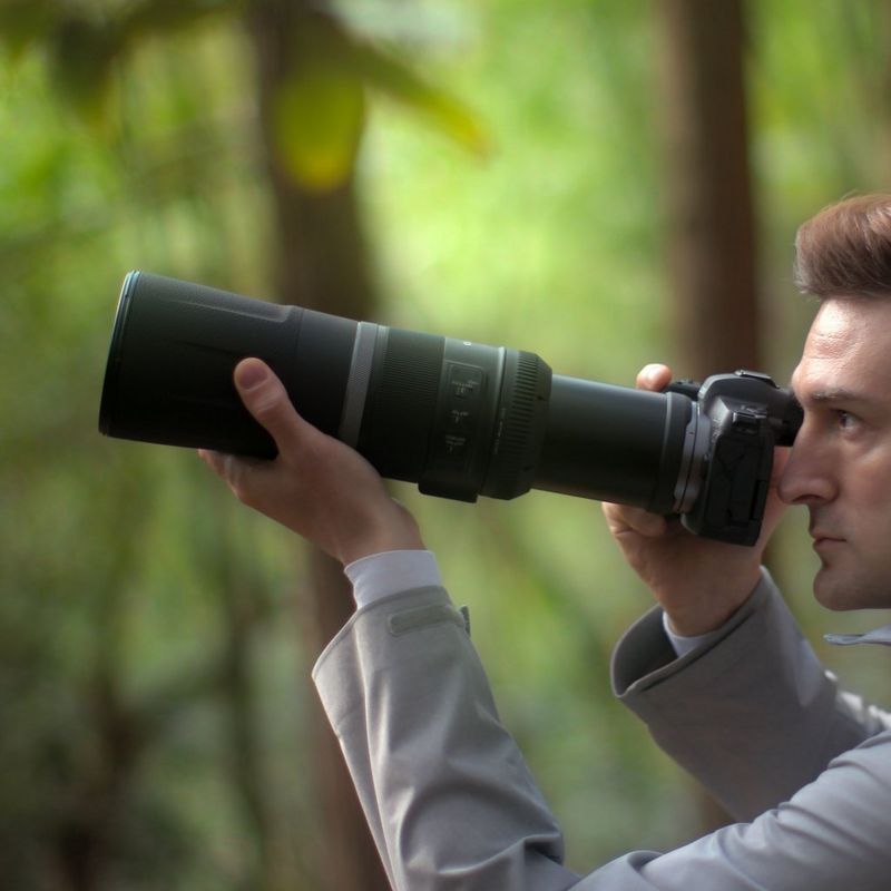Canon RF 800mm F11 IS STM Lens A Man Holding a Camera to His Face