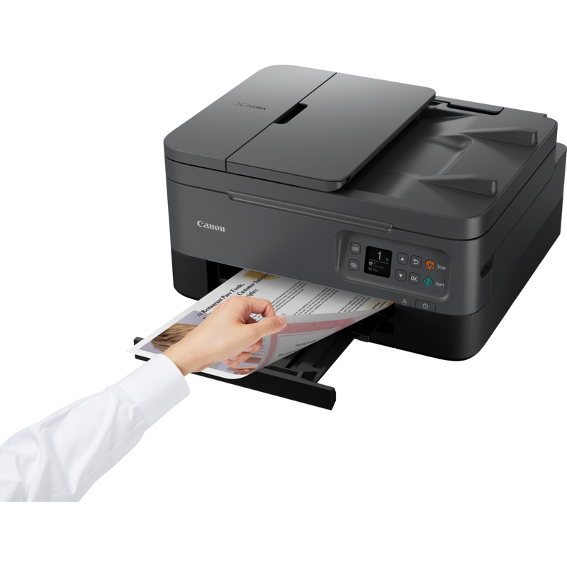 Canon PIXMA TS7450 Wireless Colour All in One Inkjet Photo Printer, Black Product Front Slant View With A Person Removing the Photo From The Paper Tray Out