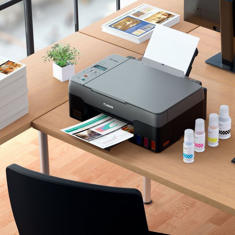 Canon PIXMA G3420 Wireless Colour 3-in-1 Refillable MegaTank Printer Kept On A Table With Paper Tray Out And Paper Support Along With Inks