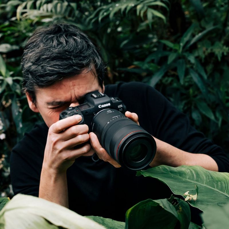 Canon RF 100mm F2.8L MACRO IS USM Lens A Man Holding a Camera to His Face