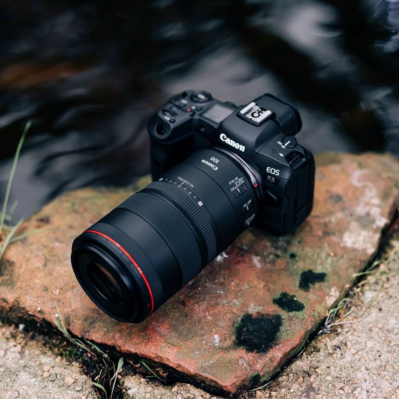 Canon RF 100mm F2.8L MACRO IS USM Lens The Lens with a Camera on a Rock