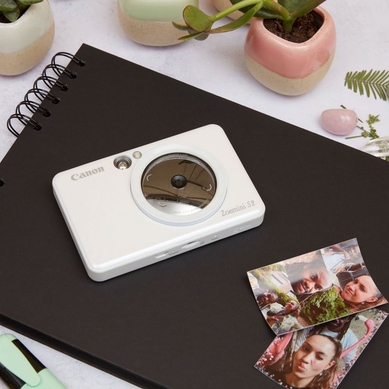 Canon Zoemini S2 Instant Camera Colour Photo Printer, Pearl White Printer on an Album with a couple of printouts