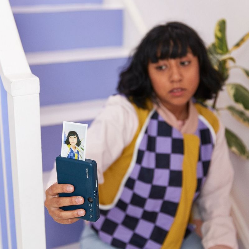 Canon Zoemini S2 Instant Camera Colour Photo Printer, Teal Women clicking a selfie with the Product