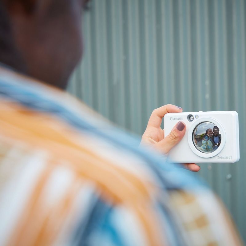 Canon Zoemini S2 Instant Camera Colour Photo Printer, Pearl White + Diary + Pouch Couple clicking a selfie visible in the lens