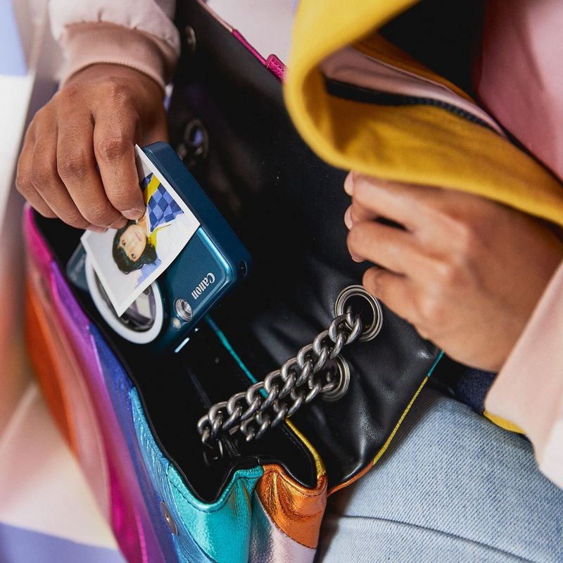 Canon Zoemini S2 Instant Camera Colour Photo Printer, Teal + Diary + Pouch Women putting the Printer in a pouch