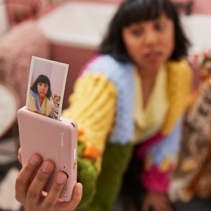 Canon Zoemini S2 Instant Camera Colour Photo Printer, Rose Gold + Diary + Pouch Women clicking a selfie with print coming out