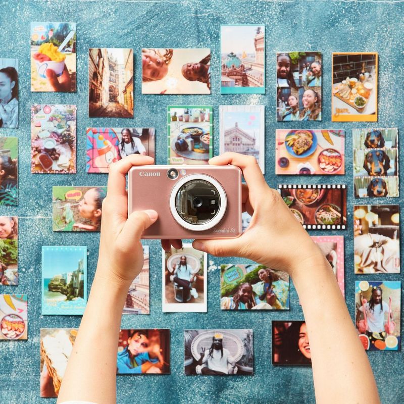 Canon Zoemini S2 Instant Camera Colour Photo Printer, Rose Gold + Diary + Pouch Printer displayed in hand with photos in the background