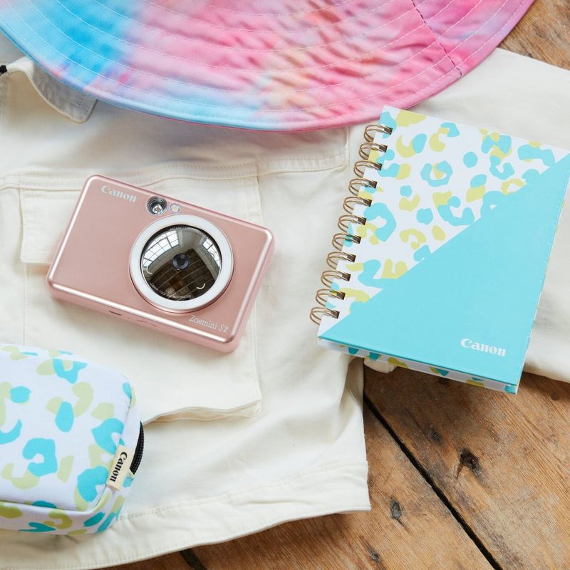 Canon Zoemini S2 Instant Camera Colour Photo Printer, Rose Gold + Diary + Pouch Printers kept on a white jacket