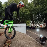 Canon Speedlite EL-1 Flash 0 Man clicking photo of a person riding a cycle