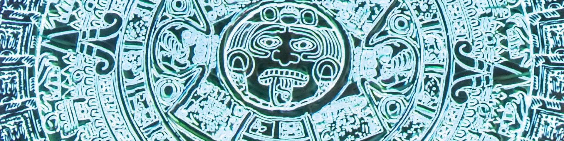Close-up detail of the projected Aztec Sunstone, showing glyphs in circles around the face of the fifth god.