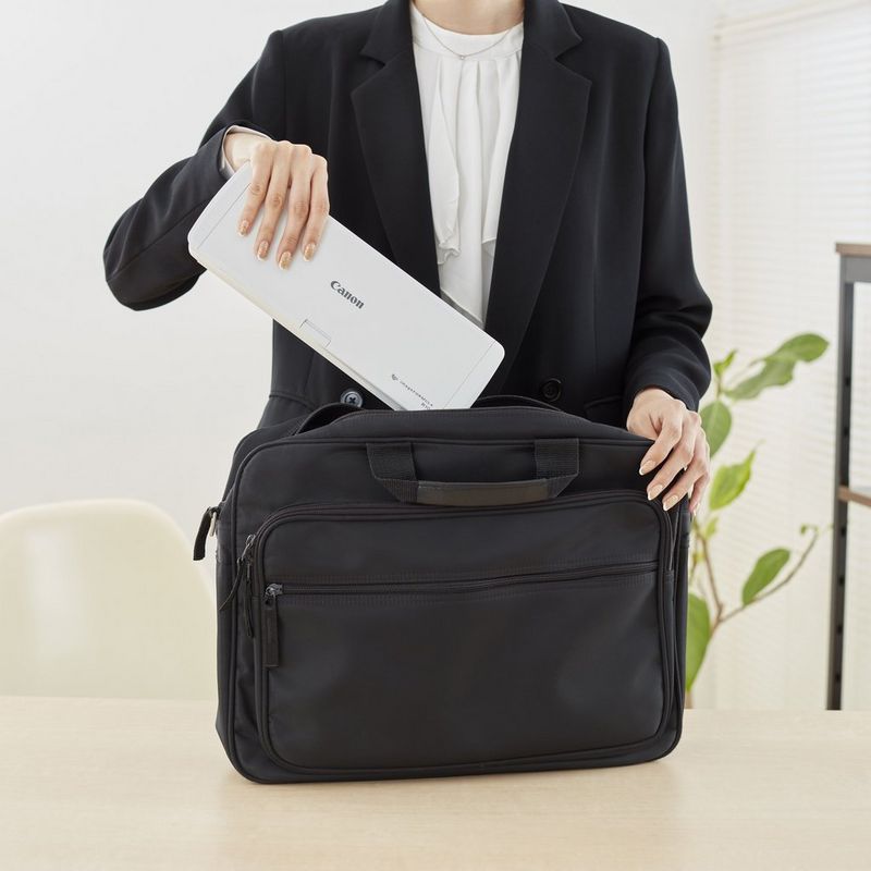 Canon imageFORMULA R10 Portable Scanner Product Person inserting the Scanner in a hand bag