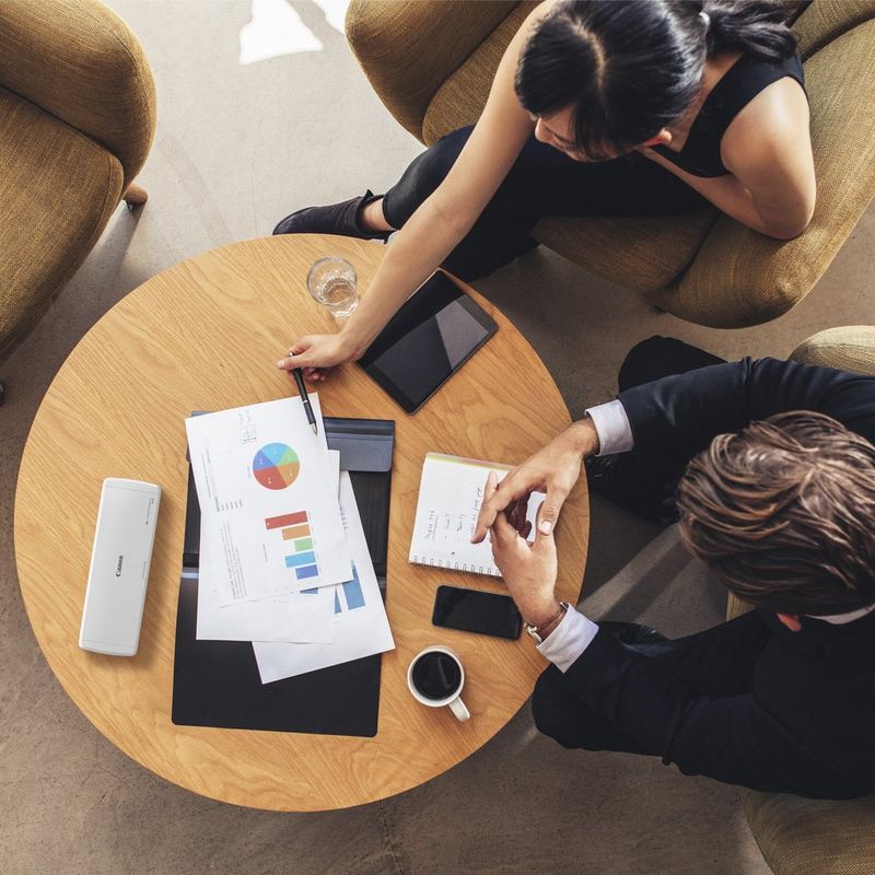 Canon imageFORMULA R10 Portable Scanner Product Scanner kept on a coffee table