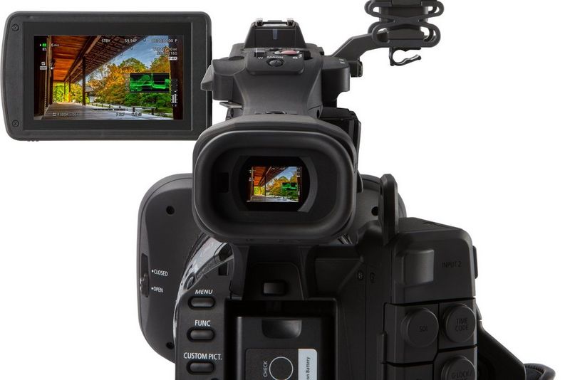 A Canon XF705 camcorder viewed from the rear with a richly coloured HDR image visible in the viewfinder and LCD screen.