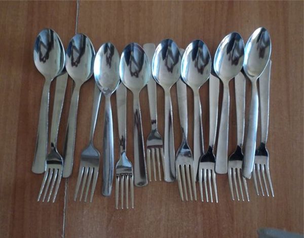 Spoons and forks lying side by side.