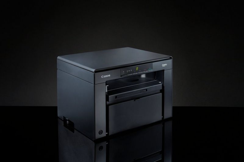 Canon i-SENSYS MF3010 3-in-1 Mono Laser Printer + 2 Black Toner Cartridges Product Right View on a black table