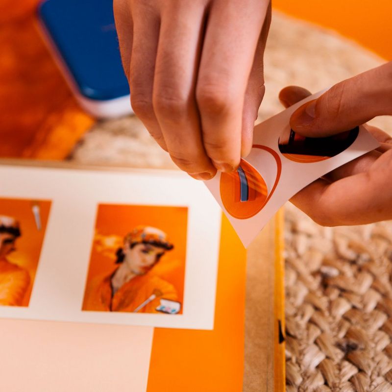 Person removing a sticker photo
