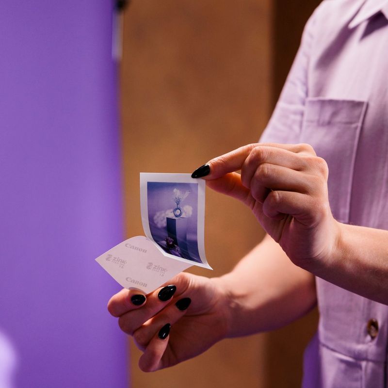 Women removing the back sticker from a photo