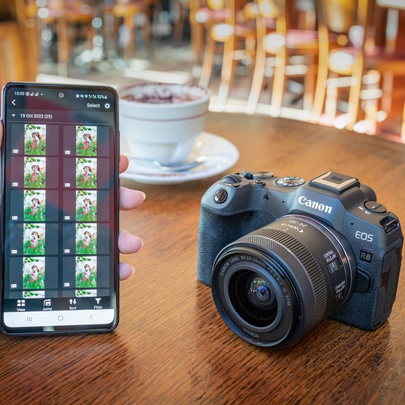 Canon EOS R8 Mirrorless Camera and RF 24-50mm F4.5-6.3 IS STM Lens A user accessing pictures on their phone using canon app
