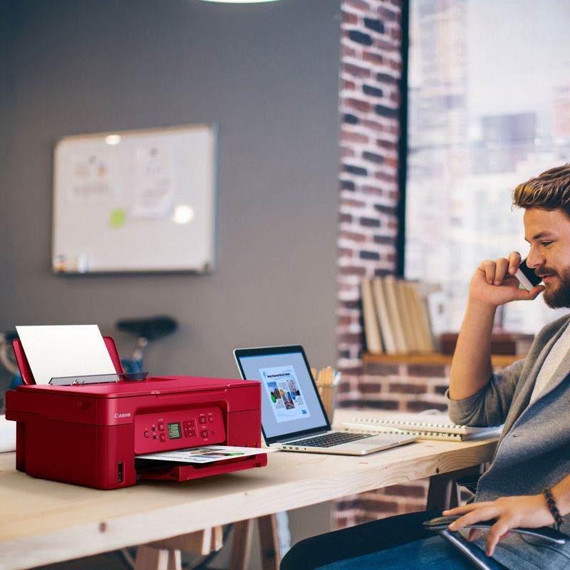 Canon PIXMA G3572 Wireless Colour 3-in-1 Refillable MegaTank Printer, Red Product kept on a Office Desk with a Man speaking on a phone