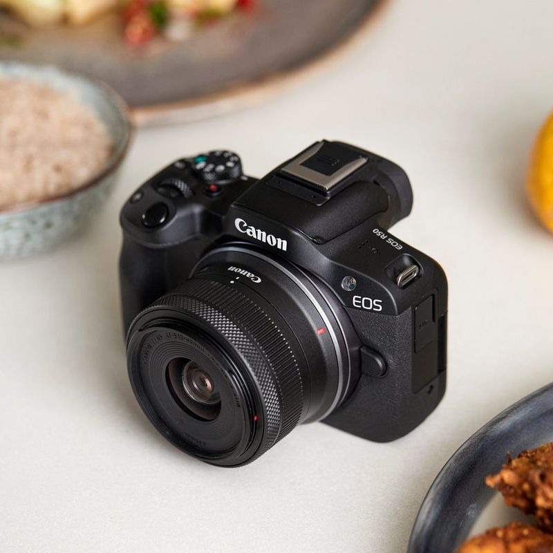 Canon EOS R50 Mirrorless Camera Body, Black Product kept on a food table
