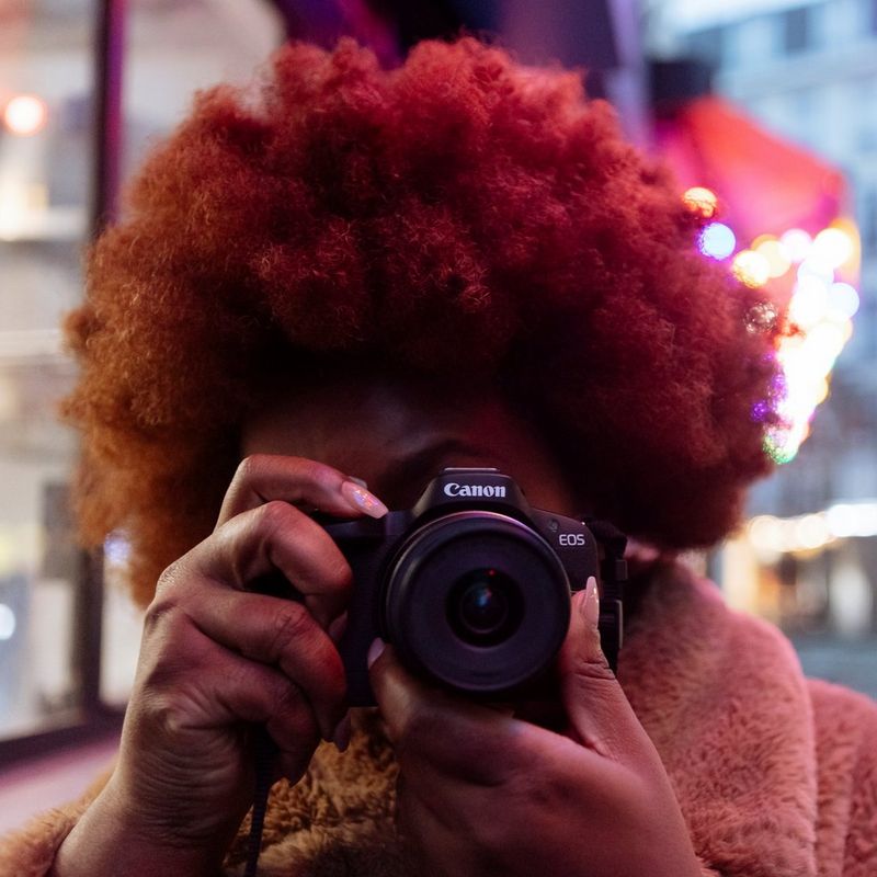 Canon EOS R50 Mirrorless Camera Body, Black Women clicking a photo