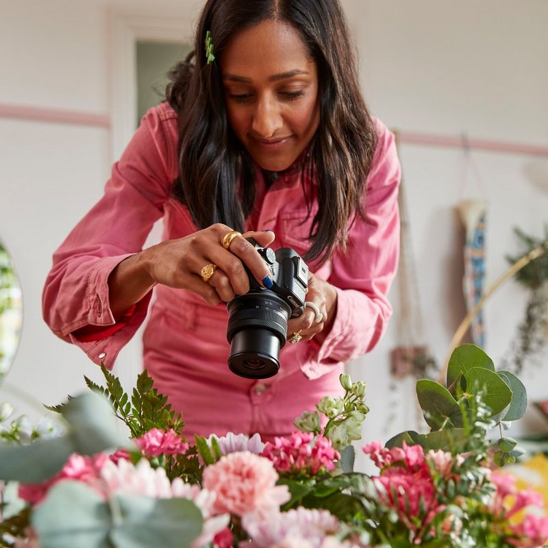 Canon EOS R50 Mirrorless Camera, Black and RF-S 18-45mm F4.5-6.3 IS STM Lens Women photographing flowers