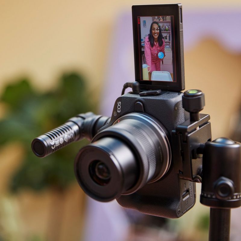 Canon EOS R50 Mirrorless Camera, Black + RF-S 18-45mm F4.5-6.3 IS STM Lens + Backpack + SD Card Product attached to Tripod