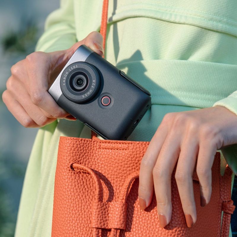 PowerShot-V10 Woman putting product in handbag