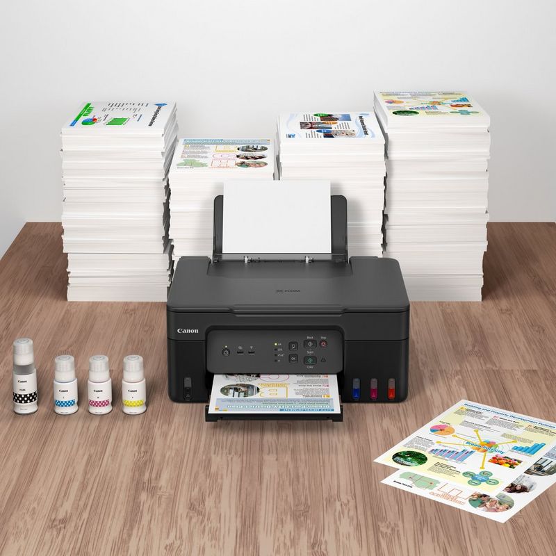 Canon PIXMA G3430 Wireless Colour 3-in-1 Refillable MegaTank Printer inks and printouts kept on a table