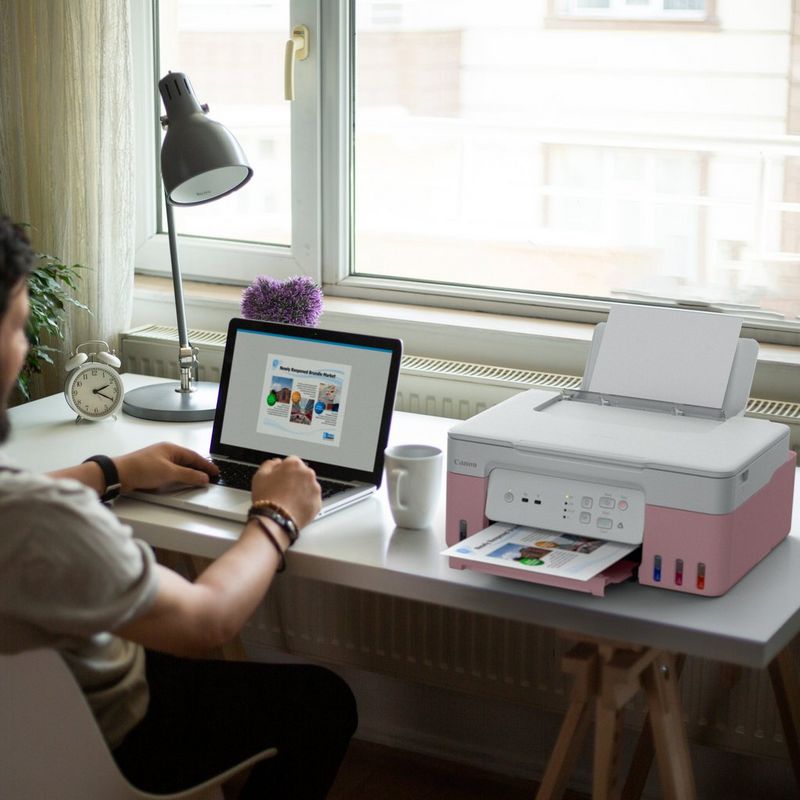 Canon PIXMA G3430 Wireless Colour 3-in-1 Refillable MegaTank Printer, Pink Product user printing a document using his laptop