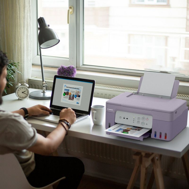 Canon PIXMA G3430 Wireless Colour 3-in-1 Refillable MegaTank Printer, VioletProduct user printing a document using his laptop