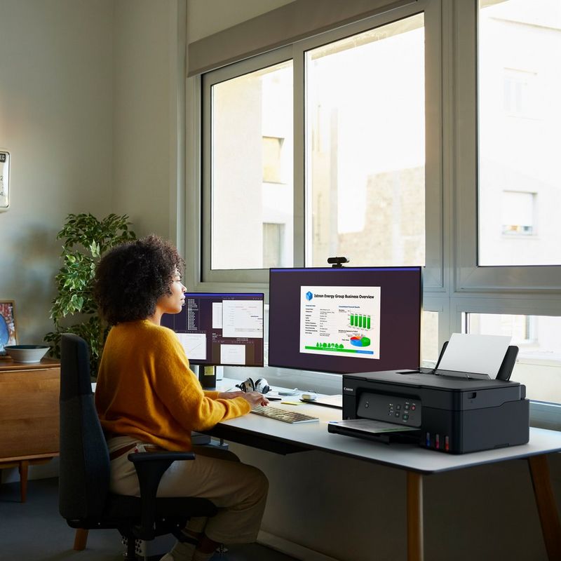Canon PIXMA G2430 Colour 3-in-1 Refillable MegaTank Printer women printing a document using her computer