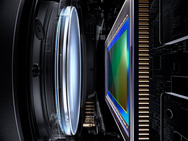 A close-up image of the back of a lens and the image sensor inside a Canon EOS R System camera.