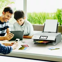 Family enjoying time together and printing photo using tablet