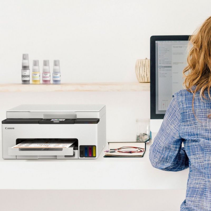 Canon MAXIFY GX1040 Wireless Colour 3-in-1 Refillable MegaTank Inkjet Printer Printer kept on a work station next to a computer