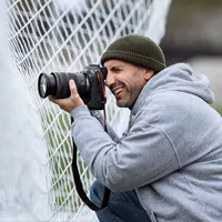 Canon EOS R1 Mirrorless Camera Body Man clicking photo on a football field