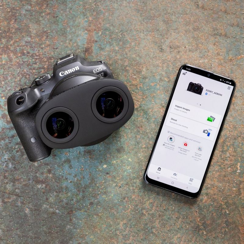 Canon RF-S 3.9mm F3.5 STM DUAL Fisheye Lens Lens fixed to a camera besides a smartphone