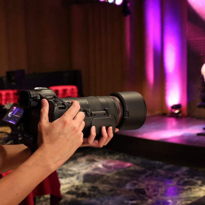 Canon RF 70-200mm F2.8L IS USM Z Lens, White Man clicking a photo on a sports field