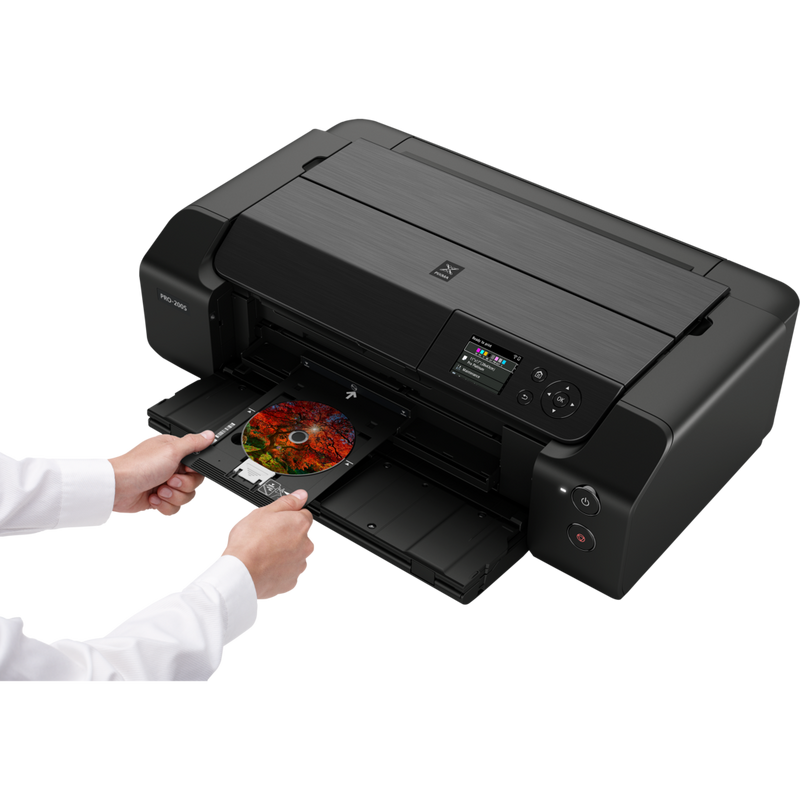 Canon PIXMA PRO-200S A3 Plus Colour Photo Wireless Printer Product Front Slant View With A Person Inserting A Compact Disc