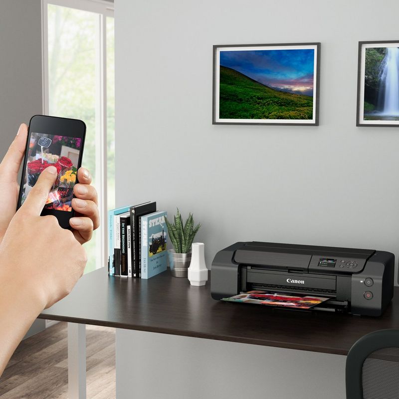 Canon PIXMA PRO-200S A3 Plus Colour Photo Wireless Printer Product Front View With A Person Printing From a Smartphone