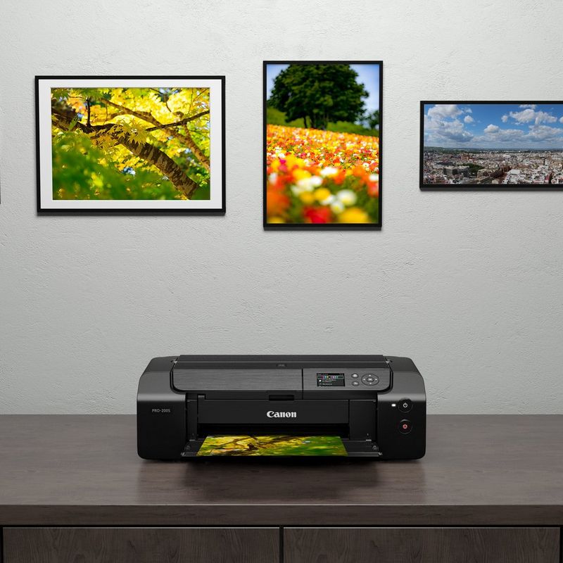 Canon PIXMA PRO-200S A3 Plus Colour Photo Wireless Printer Product Front View kept on table with printouts on the wall