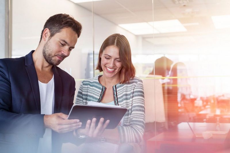 two people holding tablet