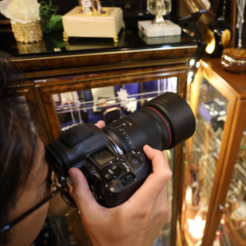 Canon RF 50mm F1.4L VCM Lens Man clicking photo in a shop