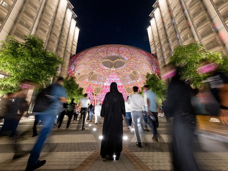 People walking towards the event location for Expo in Dubai.