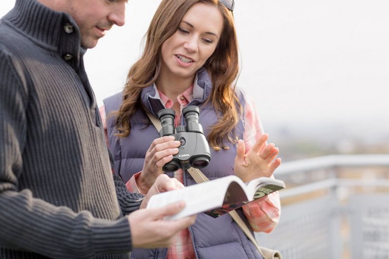 A women holding a binocular for occasional spotting 