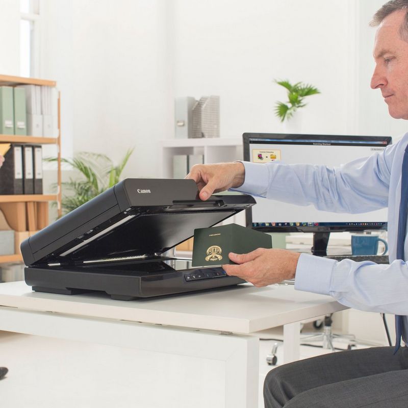 Canon imageFORMULA DR-F120 Flatbed Document Scanner Product Person scanning a passport