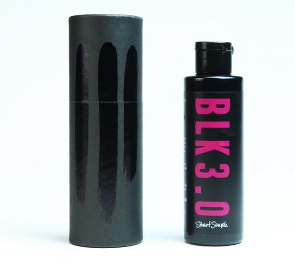 A bottle of Black 3.0 next to a sample of its colour against a standard black acrylic.