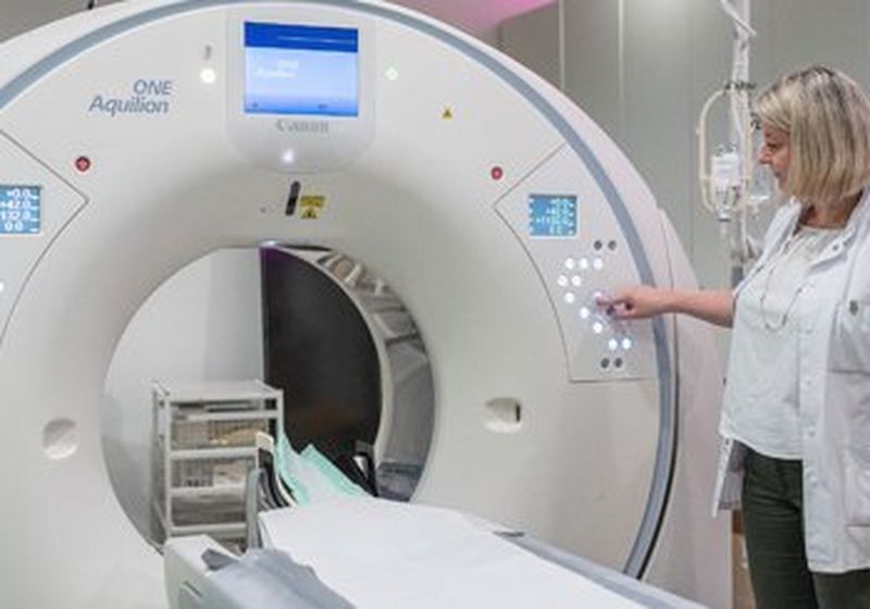 A female doctor pushes a button on Canon Aquilion ONE GENESIS CT Scanner